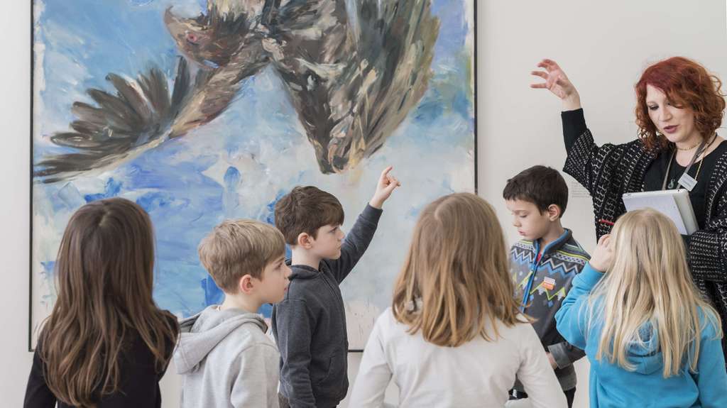 Children workshop takes place in front of a blue painting