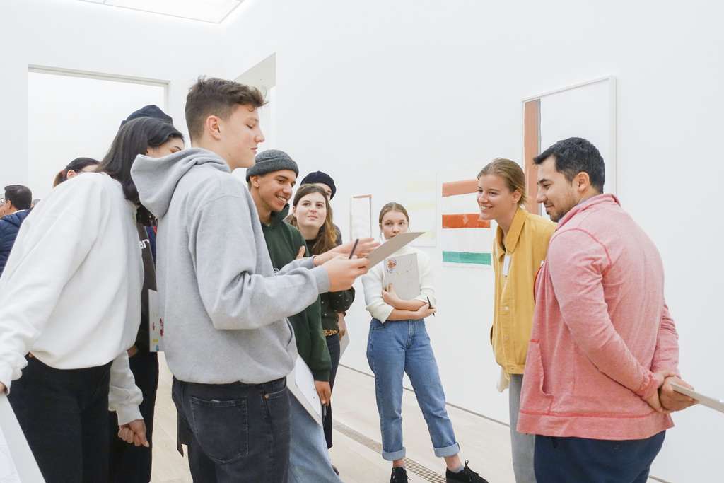 Young people discuss togeather in museum.